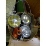 Three vintage car headlamps and other garage items