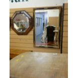 Mahogany octagonal bevelled edge mirror and a black and gilt framed bevelled edge mirror