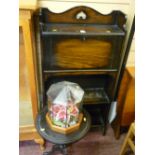 Compact slim two shelf bookcase with drop down bureau, a small black tripod wine table and a glass