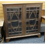 A vintage oak carved & glazed bookcase on bracket feet, 115cms wide Condition Report: please