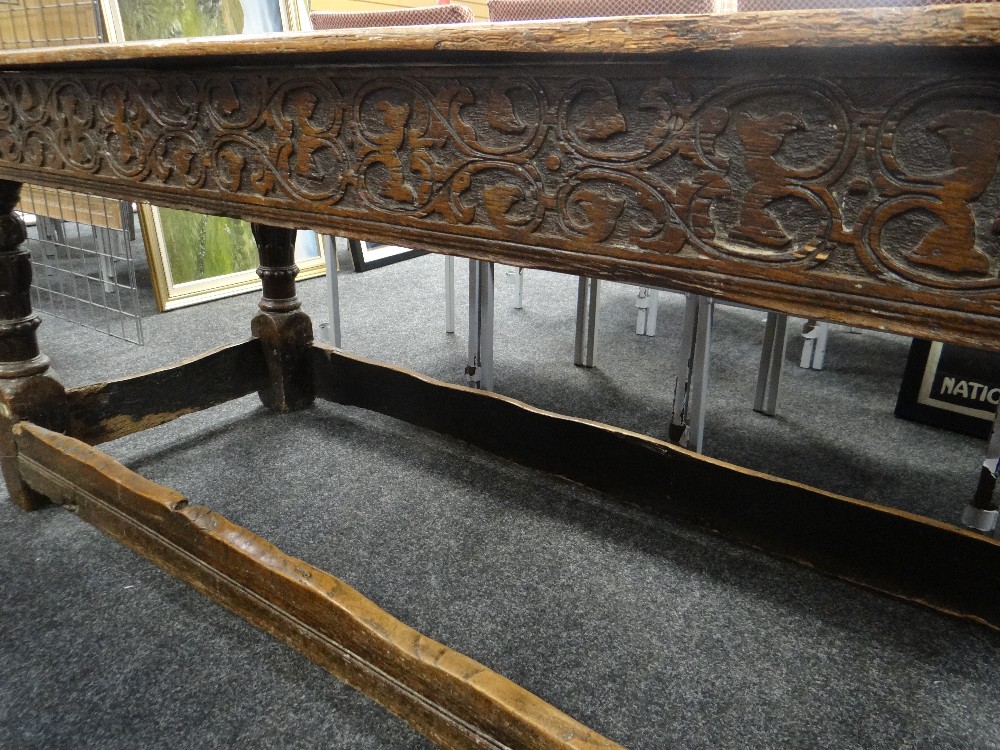 A believed eighteenth century carved oak refectory table, the top with three planks, carved frieze - Image 2 of 4