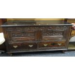 An unusual antique carved oak Lancashire-chest with two base drawers, hinged two-plank lid & the