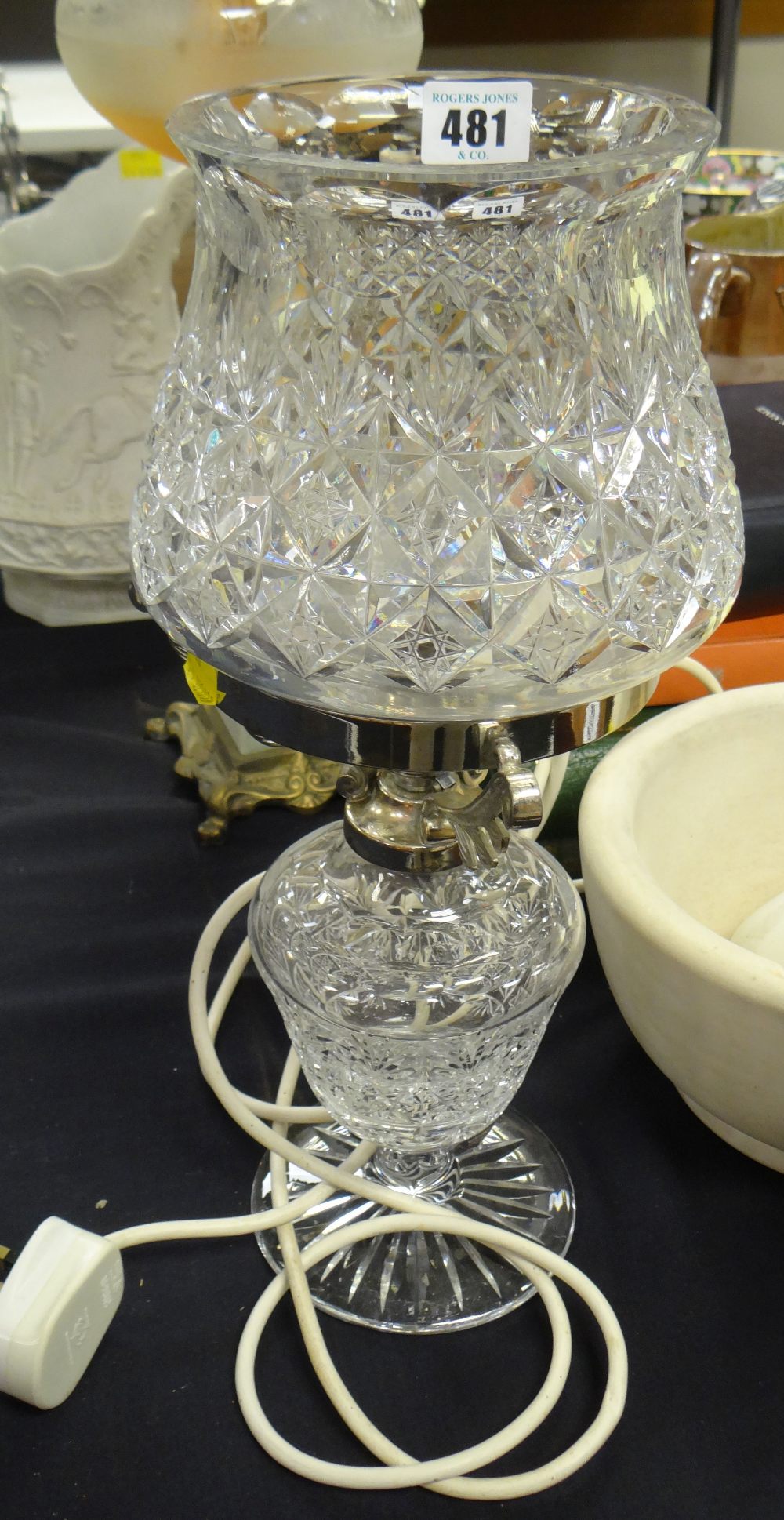 A fine quality cut glass & chromed oil lamp of shaped form on a spreading foot Condition Report: