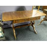 A good antique reproduction crossbanded mahogany drop-flap sofa-table with two drawers on lyre-