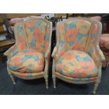 A pair of modern carved French-style elbow chairs with bright floral upholstery Condition Report: