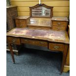 An antique rosewood writing desk by Maple & Co with marquetry serpentine covered stationary cabinet,