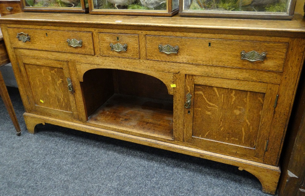 Early twentieth century oak dressing base having two long & one short drawer above open dog