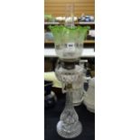 A cut glass oil lamp having a stepped base & fluted tapered column, cut glass reservoir & tinted