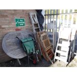 A large teak garden table, parasol, chairs, step ladders ETC (outside) Condition Report: please