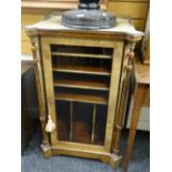 An antique walnut & ebonized single-door music cabinet with inlaid decoration, the architectural