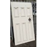 A large painted white pitch pine three-panelled front door together with a cast iron knocker (