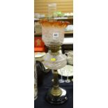 An antique oil lamp with black pottery base, Corinthian brass column stem & pink swirl glass