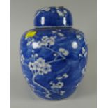 A Chinese blue & white prunus decorated provision jar & cover with character marks to the base