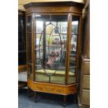 An attractive antique display cabinet in the manner of Edwards & Roberts with single centre oval