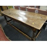 A believed eighteenth century carved oak refectory table, the top with three planks, carved frieze