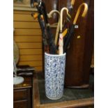 A blue & white pottery stick stand & contents Condition Report: please request* *Condition is not