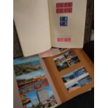 A stamp album & sparsely completed contents together with a scrapbook of vintage postcards Condition