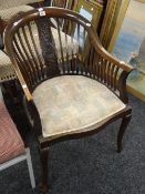 A twentieth century mahogany spindle back tub-type chair with serpentine front & tapestry seat