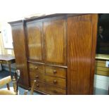 A Victorian mahogany triple breakfront wardrobe composed of flanking hanging space, press cupboard