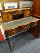 Reproduction flame mahogany finish writing desk with leather tooled inset top
