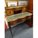 Reproduction flame mahogany finish writing desk with leather tooled inset top