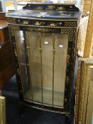 An early twentieth century black lacquer chinoiserie-style single door china cabinet on ball &