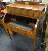 Early twentieth century inlaid mahogany writing desk having tambour rolled top front revealing
