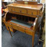 Early twentieth century inlaid mahogany writing desk having tambour rolled top front revealing