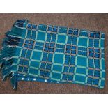 A good Welsh blanket of traditional form with green / blue ground & geometric checker decoration