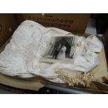 A boxed 1950s satin bodice wedding dress with beaded neckline, silk net veil, in original box (