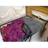 A vintage suitcase containing Welsh blanket waistcoats & a vanity case with contents Condition