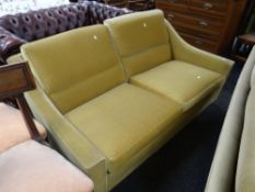 A retro circa 1960s / 70s two-seater mustard upholstered sofa by Howard Keith Condition Report: