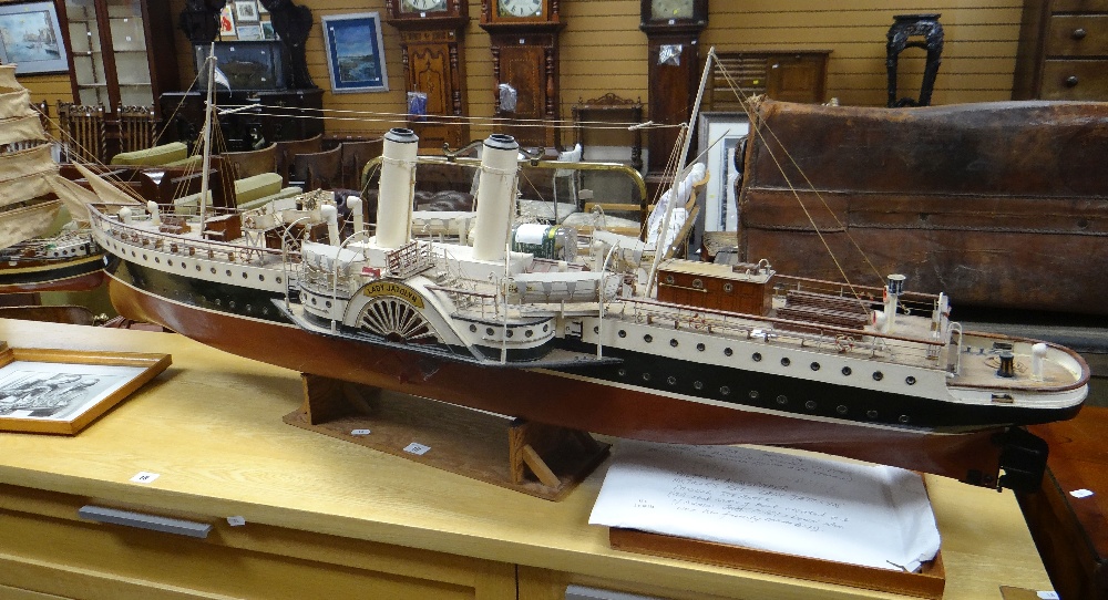 A substantial motorised model of a paddle steamer named Lady Jatolyn, 142cms long on wooden stand (