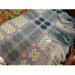 A Derw Mill Welsh blanket in pale blue ground and green, yellow & cream geometric decoration with