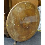 An antique circular marquetry-walnut breakfast-table complete with circular glass protector on an