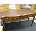 A good quality inlaid mahogany serpentine front sideboard of three drawers raised on tapered