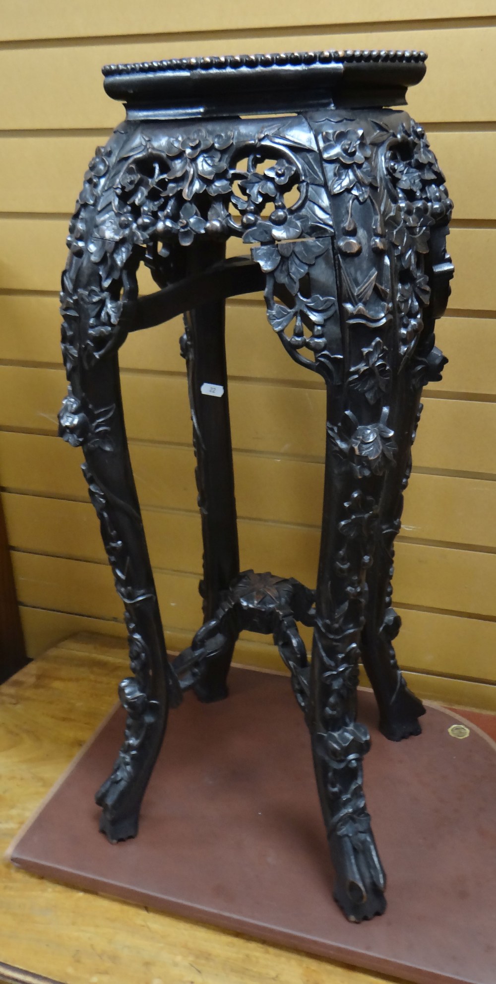 An ebonized & naturalistically carved Oriental planter stand with marble insert top, 76cms high.