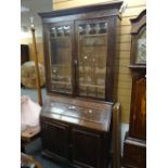 A vintage oak bureau bookcase with glazed doors above cupboard base, 214cms high x 110cms wide x