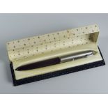 A VINTAGE BURGUNDY PARKER 51 FOUNTAIN PEN with lustraloy cap with chrome plated clip & jewel, in