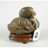 CHINESE SPINACH JADE STUDY OF A BIRD with finely incised wings to either side, modelled holding a