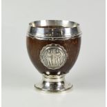 GEORGE V SILVER MOUNTED COCONUT SHELL GOBLET, raised on circular base with applied 1860 The National
