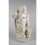 CHINESE BLANC DE CHINE FIGURE OF A STANDING BUDDHA ON HARDWOOD OVAL BASE unmarked, 26cms high