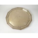 GEORGE V SILVER SALVER of dodecagon form raised on four feet, having engraved initials " B-D".