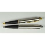 TWO MODERN STAINLESS STEEL PARKER FRONTIER BALLPOINT PENS one with gold plated trim