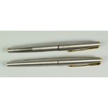 TWO VINTAGE STAINLESS STEEL PARKER 65 FLIGHTER DELUXE FOUNTAIN PENS 14ct gold nibs & gold trims