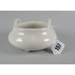 CHINESE TWIN-HANDLED POTTERY CENSER raised on three feet, in white glaze, unmarked, 13cms at