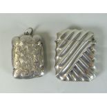 TWO SIMILAR SILVER VESTA CASES, one of raised rib design and the other overall engraved and named "