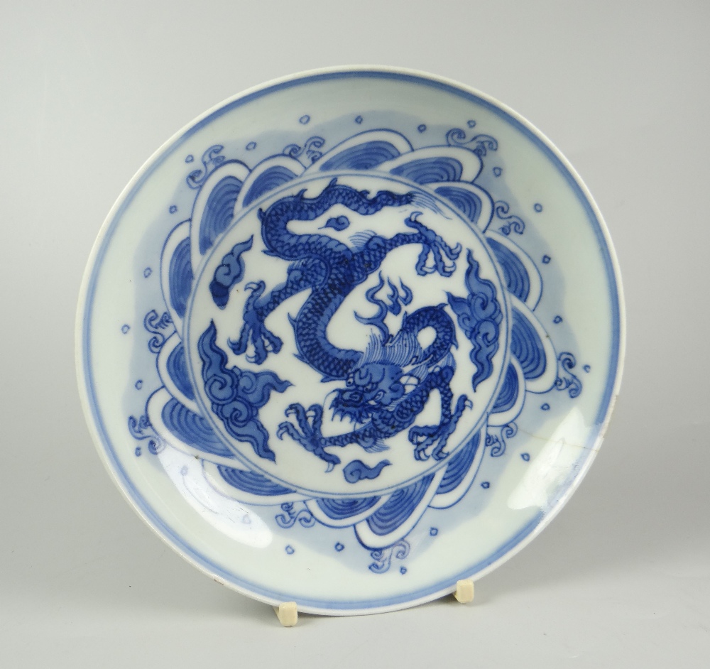 CHINESE PORCELAIN BLUE & WHITE SHALLOW DISH depicting four clawed dragon chasing a flaming pearl