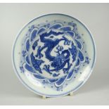 CHINESE PORCELAIN BLUE & WHITE SHALLOW DISH depicting four clawed dragon chasing a flaming pearl