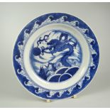 CHINESE PORCELAIN BLUE & WHITE SHALLOW DISH depicting four clawed dragon chasing a flaming pearl